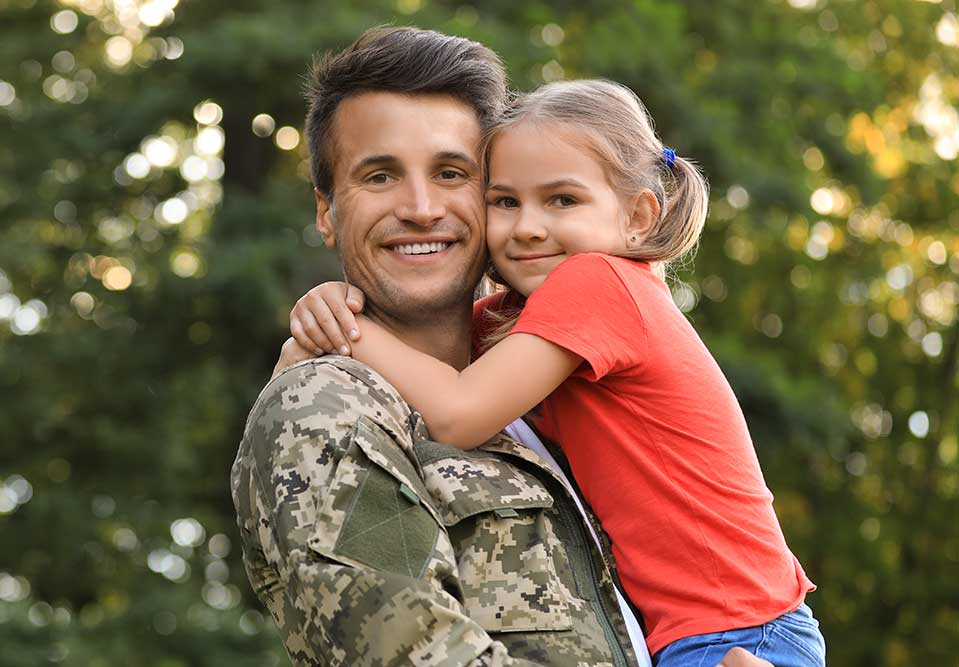 a man in a military uniform holds a child