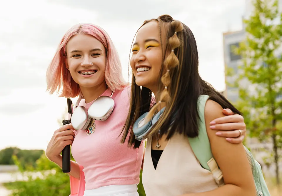 two teenage girls walk together