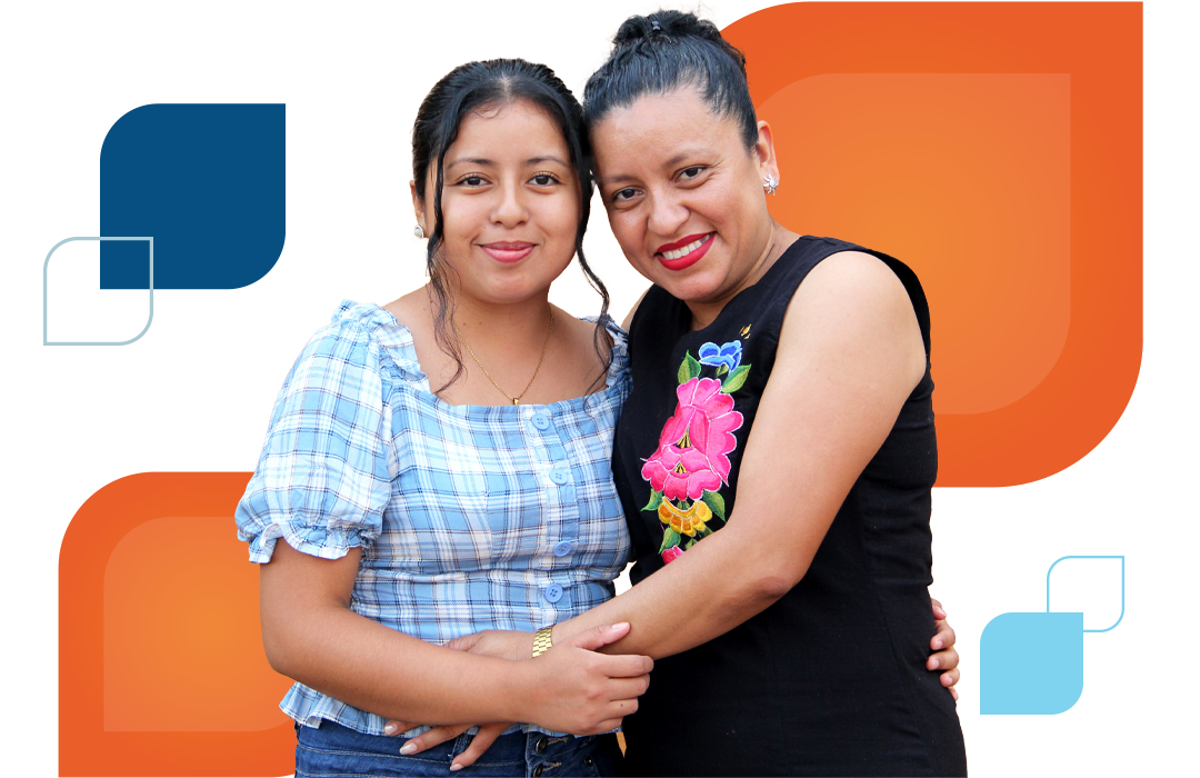 an adult woman and a young woman hug and face the camera