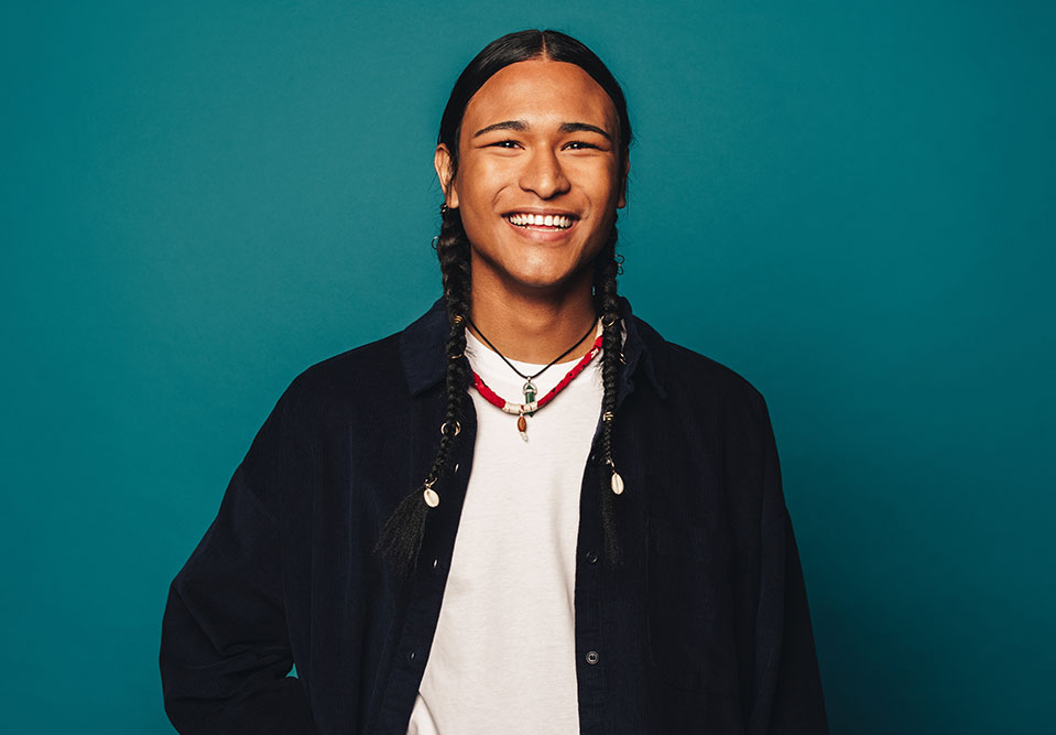 a young man smiles at the camera
